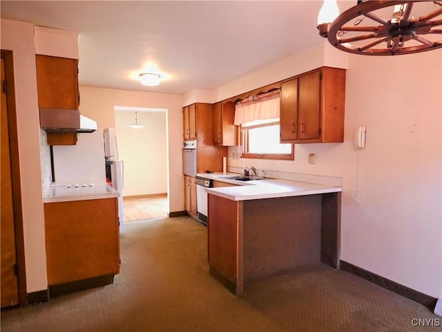 7742 Davis Rd S, Clay, NY 13212 - kitchen featuring oven, brown cabinets, white dishwasher, and a peninsula