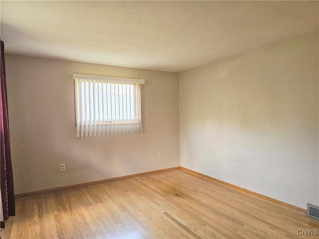 7742 Davis Rd S, Clay, NY 13212 - unfurnished room with wood finished floors and baseboards