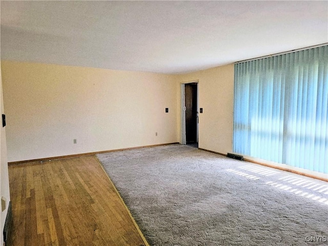 7742 Davis Rd S, Clay, NY 13212 - empty room with baseboards and wood finished floors
