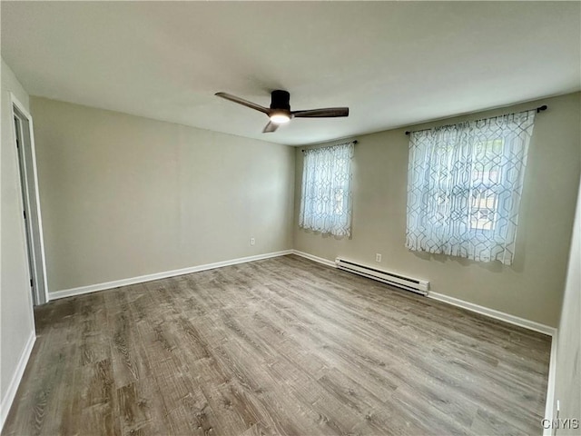 8408A Shallowcreek Rd, Clay, NY 13090 - spare room with a baseboard radiator, wood finished floors, ceiling fan, and baseboards