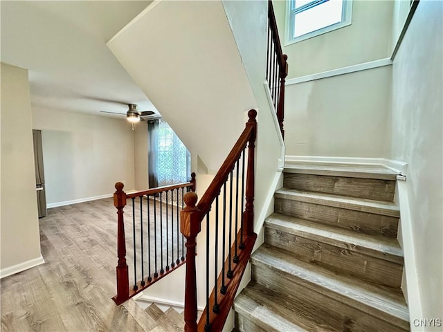 8408A Shallowcreek Rd, Clay, NY 13090 - staircase featuring baseboards, wood finished floors, and ceiling fan