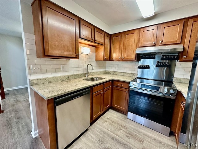 8408A Shallowcreek Rd, Clay, NY 13090 - kitchen with appliances with stainless steel finishes, range hood, a sink, and light wood-style floors