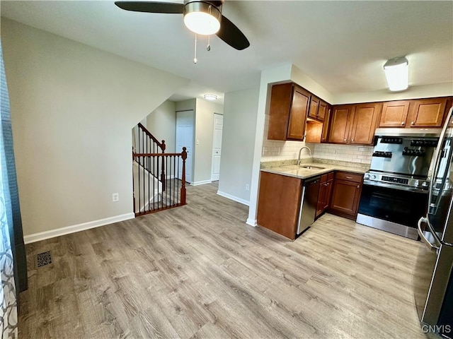 8408A Shallowcreek Rd, Clay, NY 13090 - kitchen with a ceiling fan, range, light wood-type flooring, baseboards, and stainless steel dishwasher
