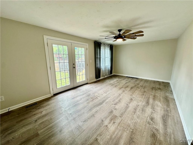 8408A Shallowcreek Rd, Clay, NY 13090 - empty room with french doors, wood finished floors, baseboards, and ceiling fan