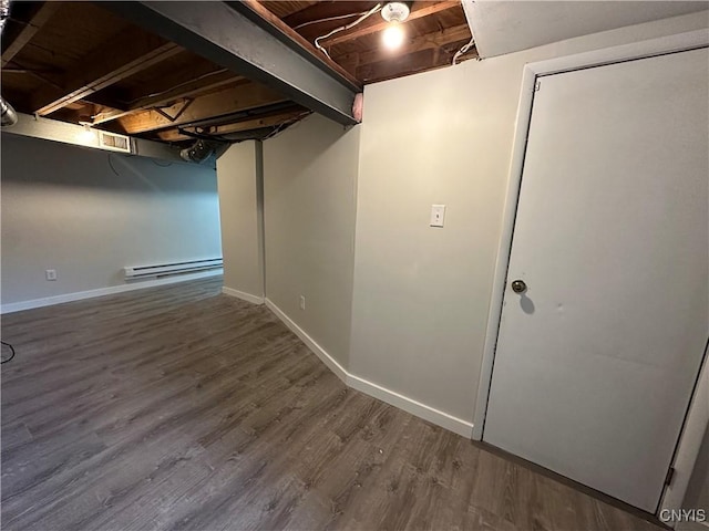 8408A Shallowcreek Rd, Clay, NY 13090 - finished basement featuring baseboard heating, wood finished floors, and baseboards