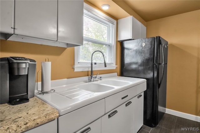 202 Tremaine Ave, Tonawanda-Town, NY 14217 - kitchen with freestanding refrigerator, white cabinetry, light countertops, and baseboards