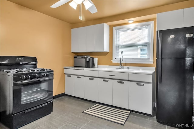 202 Tremaine Ave, Tonawanda-Town, NY 14217 - kitchen featuring black appliances, ceiling fan, light countertops, a sink, and white cabinets