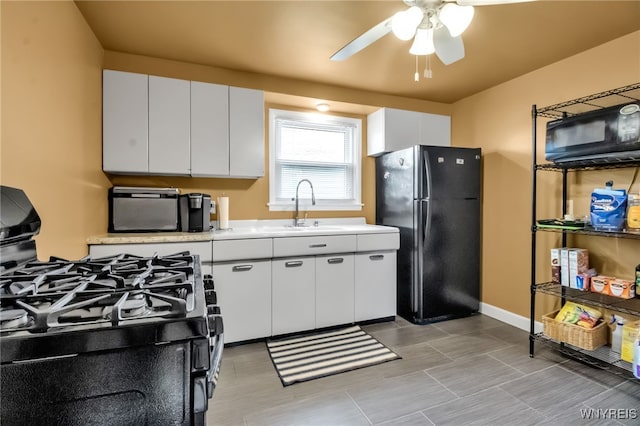 202 Tremaine Ave, Tonawanda-Town, NY 14217 - kitchen featuring black appliances, a sink, light countertops, a ceiling fan, and white cabinetry