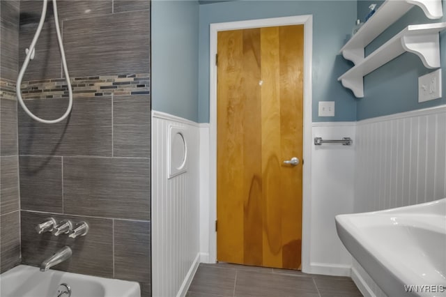 202 Tremaine Ave, Tonawanda-Town, NY 14217 - bathroom featuring a wainscoted wall, tile patterned flooring, and tub / shower combination