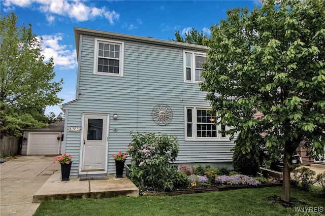 202 Tremaine Ave, Tonawanda-Town, NY 14217 - rear view of property with an outdoor structure, a lawn, and driveway