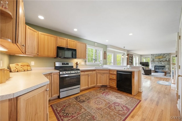 8105 Wilbarham Run, Pompey, NY 13104 - kitchen featuring black appliances, a sink, light wood-type flooring, a peninsula, and light countertops