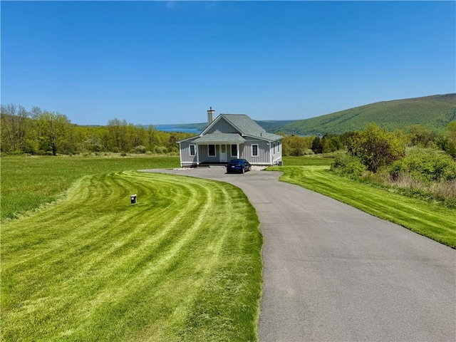 6731 County Road 12th Rd, South Bristol, NY 14512 - view of front of house featuring driveway, a front yard, and board and batten siding
