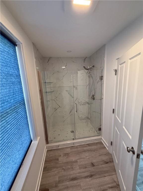 6731 County Road 12th Rd, South Bristol, NY 14512 - bathroom featuring a marble finish shower, wood finished floors, and baseboards