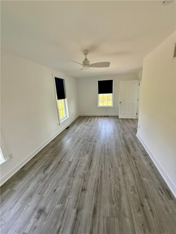 6731 County Road 12th Rd, South Bristol, NY 14512 - unfurnished room featuring a ceiling fan, wood finished floors, and baseboards
