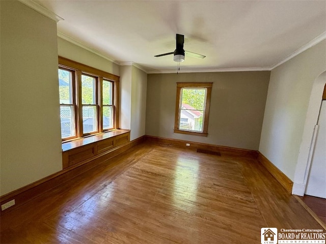 21 Juliet St, Jamestown, NY 14701 - unfurnished room with wood finished floors, crown molding, ceiling fan, arched walkways, and baseboards