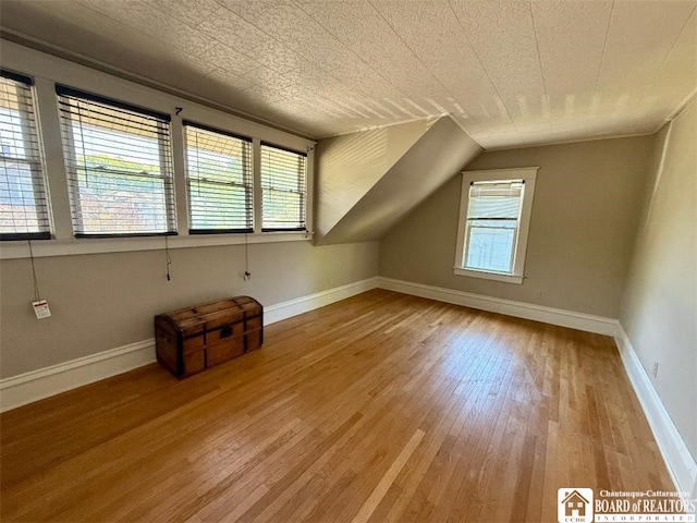 21 Juliet St, Jamestown, NY 14701 - additional living space with hardwood / wood-style floors, baseboards, and vaulted ceiling