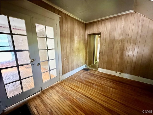 3628 S Salina St, Syracuse, NY 13205 - unfurnished room featuring wooden walls, hardwood / wood-style floors, healthy amount of natural light, french doors, and crown molding