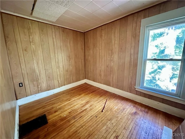 3628 S Salina St, Syracuse, NY 13205 - unfurnished room with plenty of natural light, hardwood / wood-style floors, wood walls, and baseboards