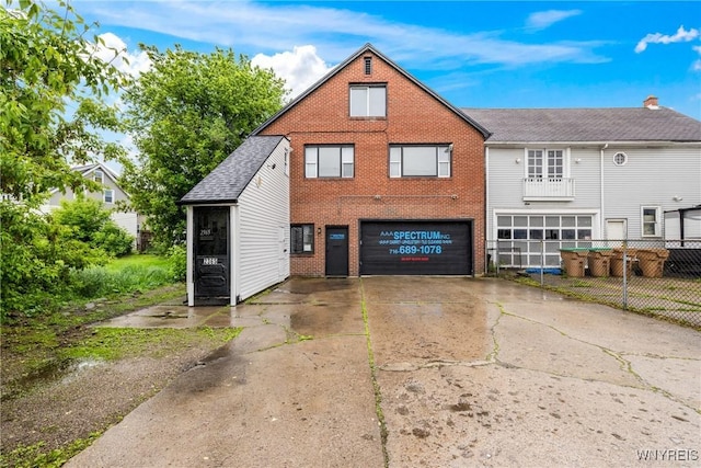 2365 Genesee St, Cheektowaga, NY 14225 - rear view of property with an attached garage, brick siding, and driveway