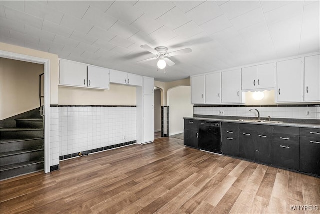 2365 Genesee St, Cheektowaga, NY 14225 - kitchen featuring a sink, black dishwasher, a ceiling fan, white cabinets, and a wainscoted wall