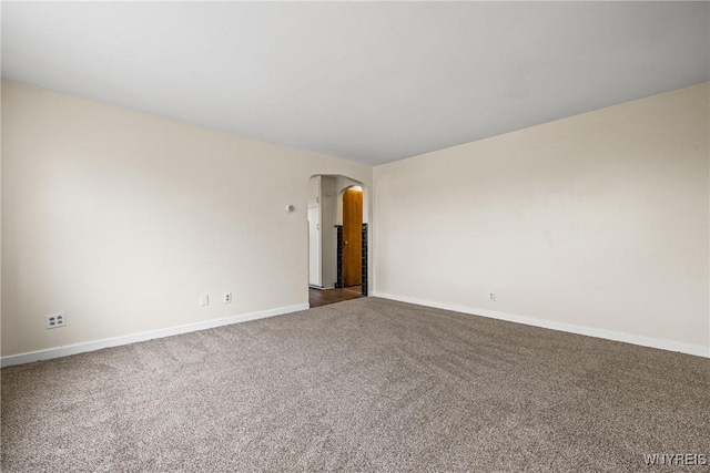 2365 Genesee St, Cheektowaga, NY 14225 - carpeted empty room featuring arched walkways and baseboards