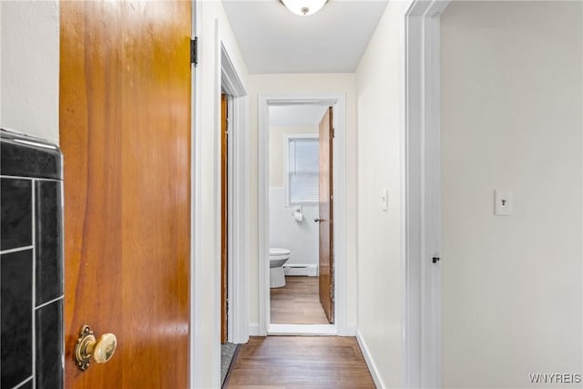 2365 Genesee St, Cheektowaga, NY 14225 - hall with a baseboard heating unit, wood finished floors, and tile walls