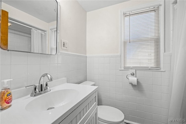 2365 Genesee St, Cheektowaga, NY 14225 - full bathroom featuring toilet, tile walls, vanity, curtained shower, and wainscoting