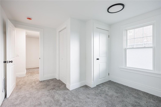 636 Ridge Rd, Webster, NY 14580 - unfurnished bedroom with light carpet, a closet, and baseboards