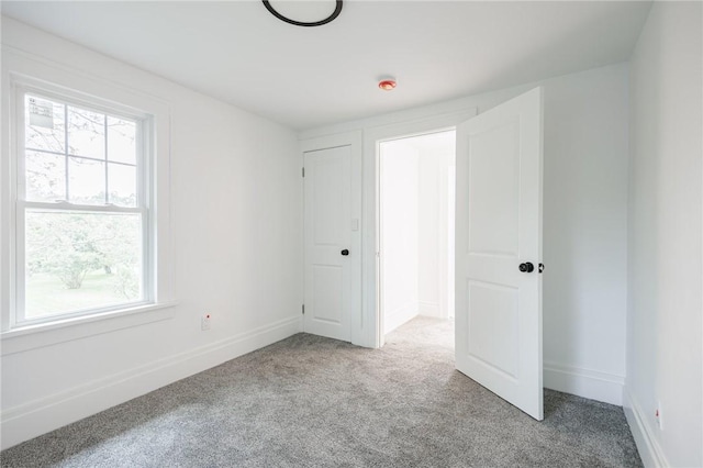 636 Ridge Rd, Webster, NY 14580 - unfurnished bedroom featuring multiple windows, carpet flooring, and baseboards