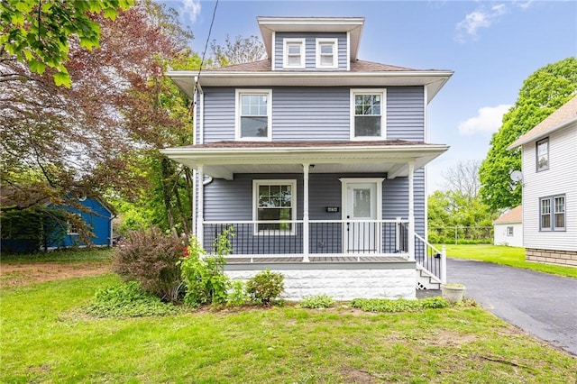 636 Ridge Rd, Webster, NY 14580 - american foursquare style home featuring a porch, a front lawn, and a shingled roof