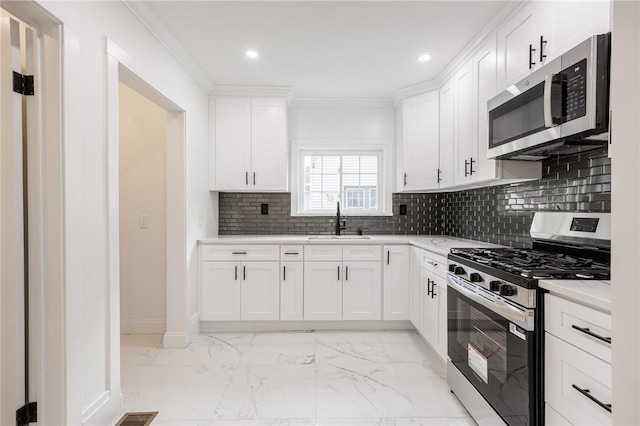 636 Ridge Rd, Webster, NY 14580 - kitchen with stainless steel appliances, a sink, light marble finish floors, recessed lighting, and ornamental molding