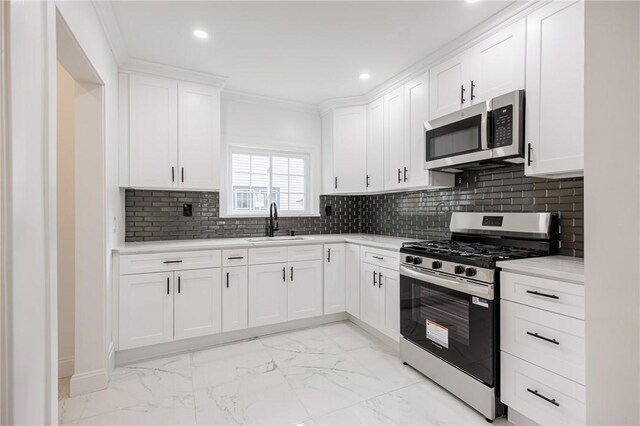 636 Ridge Rd, Webster, NY 14580 - kitchen featuring stainless steel appliances, a sink, light marble finish flooring, recessed lighting, and ornamental molding