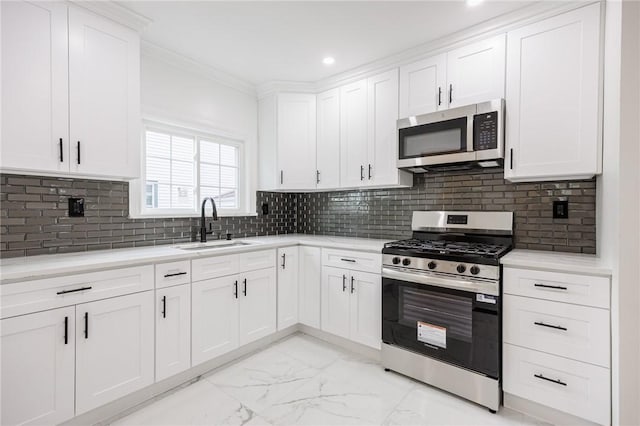 636 Ridge Rd, Webster, NY 14580 - kitchen featuring stainless steel appliances, a sink, light marble finish floors, white cabinets, and recessed lighting