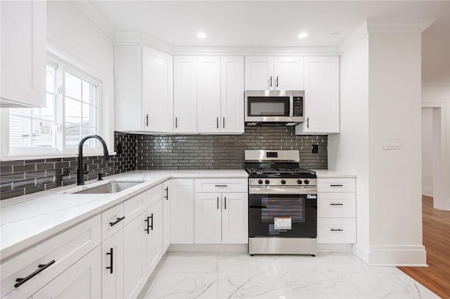 636 Ridge Rd, Webster, NY 14580 - kitchen featuring stainless steel appliances, a sink, baseboards, light stone countertops, and white cabinetry