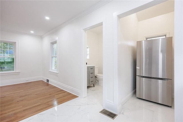 636 Ridge Rd, Webster, NY 14580 - kitchen with freestanding refrigerator, light marble finish flooring, baseboards, ornamental molding, and recessed lighting