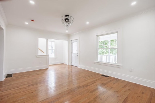 636 Ridge Rd, Webster, NY 14580 - empty room with plenty of natural light, crown molding, a chandelier, light wood-type flooring, and recessed lighting