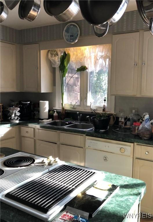 148 Marlin Rd, Grand Island, NY 14072 - kitchen featuring dishwasher, a sink, dark countertops, and white cabinets