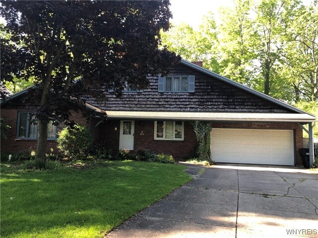 148 Marlin Rd, Grand Island, NY 14072 - view of front of house featuring driveway, an attached garage, a front yard, and brick siding