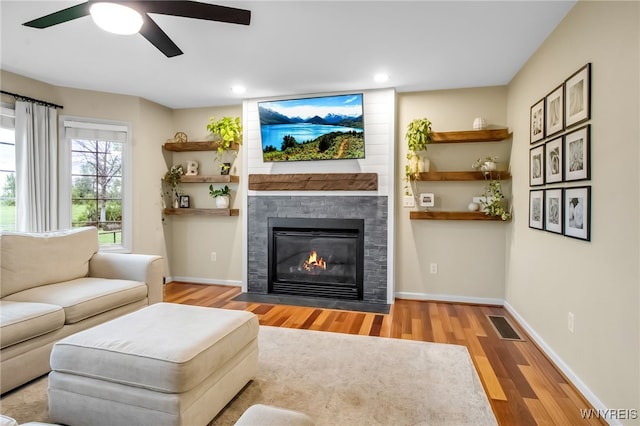 4343 Lockport Rd, Cambria, NY 14094 - living area with a ceiling fan, wood finished floors, a large fireplace, recessed lighting, and baseboards