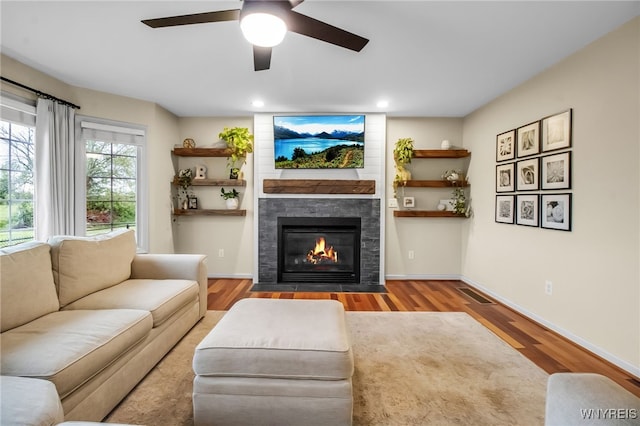 4343 Lockport Rd, Cambria, NY 14094 - living room featuring wood finished floors, ceiling fan, a fireplace, recessed lighting, and baseboards
