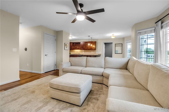 4343 Lockport Rd, Cambria, NY 14094 - living area with ceiling fan, light wood finished floors, and baseboards