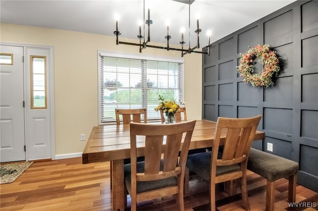 4343 Lockport Rd, Cambria, NY 14094 - dining space with light wood finished floors, baseboards, and a chandelier