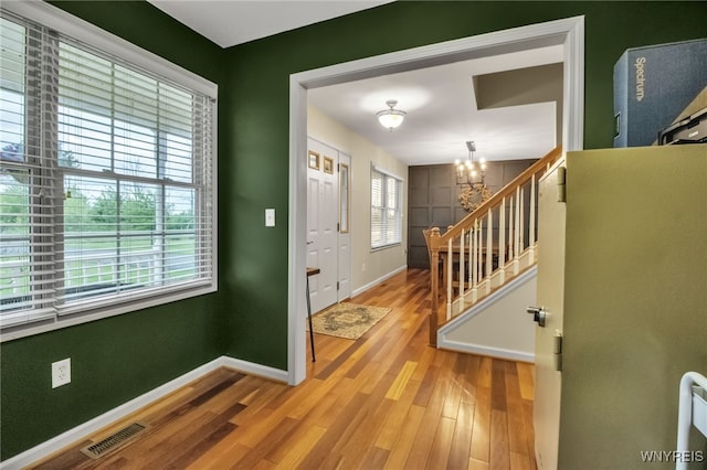 4343 Lockport Rd, Cambria, NY 14094 - entryway with a chandelier, baseboards, wood finished floors, and stairway