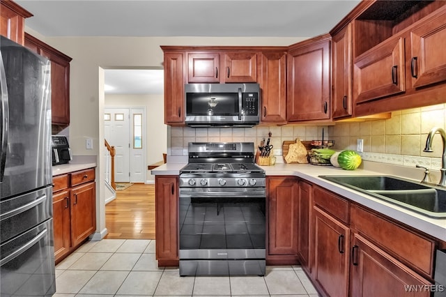 4343 Lockport Rd, Cambria, NY 14094 - kitchen with stainless steel appliances, a sink, light countertops, and backsplash