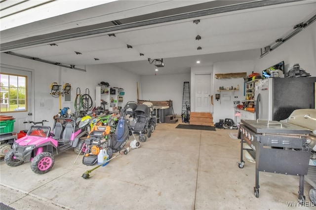 4343 Lockport Rd, Cambria, NY 14094 - garage with freestanding refrigerator and a garage door opener