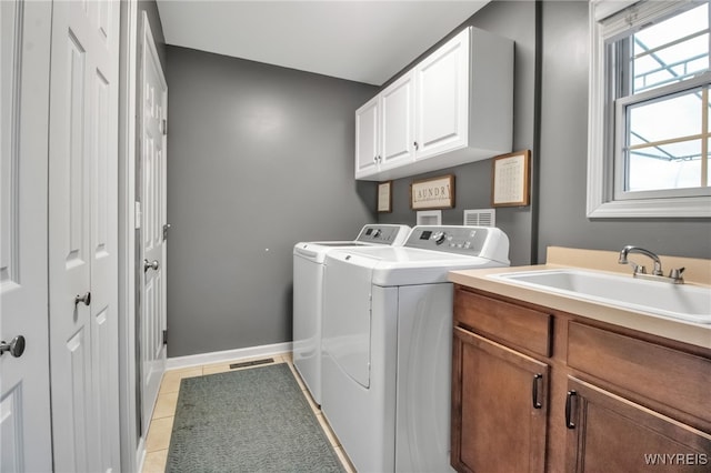 4343 Lockport Rd, Cambria, NY 14094 - laundry room with cabinet space, washer and clothes dryer, and light tile patterned flooring