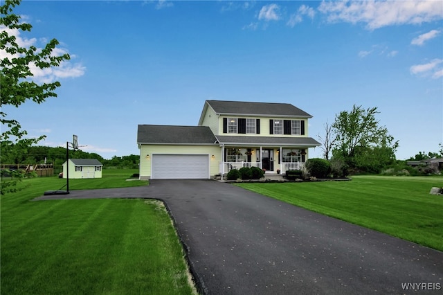 4343 Lockport Rd, Cambria, NY 14094 - colonial-style house with a porch, a garage, driveway, and a front yard