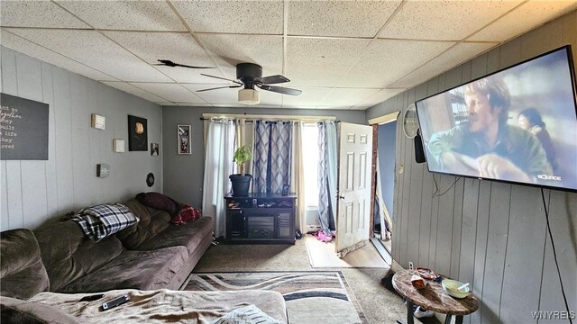 55 Lewis St, Buffalo, NY 14206 - carpeted living area featuring a ceiling fan, a paneled ceiling, and wooden walls