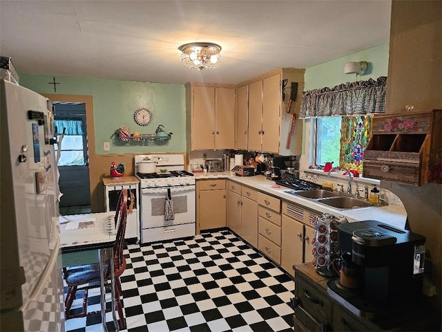 31 S Main St, Cohocton, NY 14826 - kitchen featuring white appliances, a sink, light countertops, light floors, and cream cabinetry