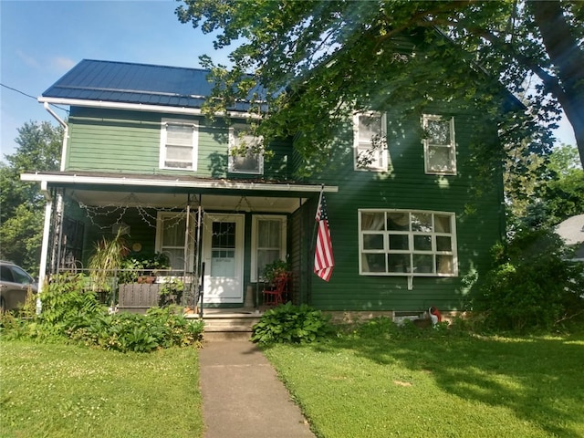 31 S Main St, Cohocton, NY 14826 - view of front facade with covered porch, a front yard, a metal roof, and a standing seam roof